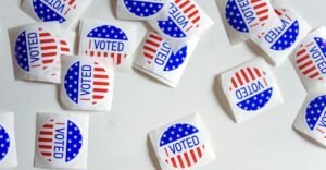 I Voted stickers on a white table.